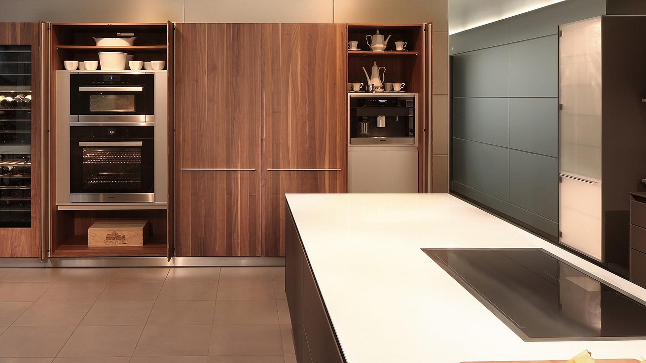 Detail view of b3 cabinets in Solid walnut with doors open showing housed appliances and stored accessories.
